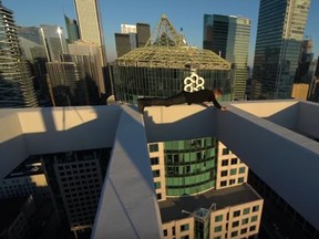 Oleg Cricket performs stunts atop a highrise in Toronto's Entertainment District. (YouTube screengrab)