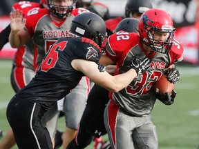 Noah Jacka of Barrie’s Bear Creek runs the ball against Thunder Bay’s St. Ignatius in the Simcoe Bowl in Hamilton yesterday. (Michael Peake/Toronto Sun)