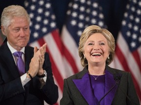 In this Wednesday, Nov. 9, 2016 file photo, former President Bill Clinton applauds as his wife, Democratic presidential candidate Hillary Clinton speaks in New York, where she conceded her defeat to Republican Donald Trump after the hard-fought presidential election. Hillary Clinton's aides and supporters are urging dispirited Democrats to channel their frustrations about the election results into political causes - just not into efforts to recount ballots in three battleground states. The former Democratic presidential candidate and her close aides see the recount drive largely as a waste of resources, according to people close to Clinton. (AP Photo/Matt Rourke, File)