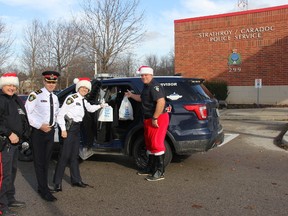 From left to right: Strathroy-Caradoc Police Service Const. Mark Thuss, Deputy Chief Mark Campbell, Chief Laurie Hayman, and Const. Kevin VanRooyen making the first donations to this year’s “Cramp a Cruiser” campaign. JONATHAN JUHA/STRATHROY AGE DISPATCH/POSTMEDIA NETWORK