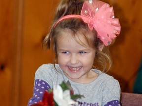Macy Vandendool, 4, is all smiles as she enjoys some baked goods and beverages at a tea and fashion show held on Friday, Nov. 25, at Knox Presbyterian. The event was a fundraiser for Active Christians With a Mission (ACWAM), who are raising money for God's Hope Christian School in Haiti which received damage in a recent hurricane.