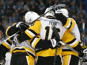 In this Nov. 5, 2016, file photo, Pittsburgh Penguins centre Eric Fehr celebrates with teammates after scoring a goal against the San Jose Sharks during the second period of an NHL game in San Jose. (AP Photo/Tony Avelar, File)