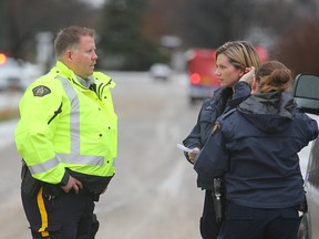 RCMP members confer on Foxgrove Avenue after two people were found shot early Monday morning. (Brian Donogh/Winnipeg Sun file photo)