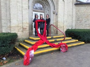 Sexual health clinic secretary Allison Law, left and public health nurses Gayle Milne, centre and Lisa Gillespie display some of the 60 red scarves that will be distributed on December 1. (Submitted photo)