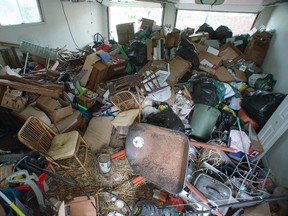 Garbage fills the garage of Simon Andrew's rental house on John F. Scott Road. (Photo courtesy Simon Andrew)