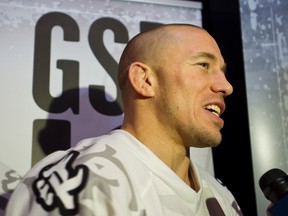 UFC fighter Georges St. Pierre speaks with the media at the Old Strathcona Rack before the Edmonton Rush's season home opener in Edmonton, Alta., on Jan. 11, 2014. (Ian Kucerak/Edmonton Sun)