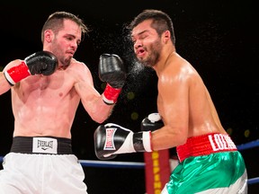 Cam O'Connell of Red Deer hits Randy Lozano (right) of Mexico during the title fight of a KO Boxing card at the Shaw Conference Centre in September, 2015. (Ian Kucerak)