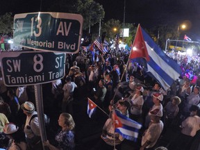Demonstrators listen to speakers at a rally Wednesday, Nov. 30, 2016, in the Little Havana neighborhood of Miami. Hundreds of Cuban exiles in Miami rallied for freedom and democracy on the communist island following the death of revolutionary leader Fidel Castro. (AP Photo/Wilfredo Lee)