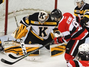 Kingston Frontenacs goalie Jeremy Helvig makes a save on Austen Keating of the Ottawa 67's during first-period OHL action at the Rogers K-Rock Centre on Wednesday night. Kingston won 2-1 in overtime. (Julia McKay/The Whig-Standard)