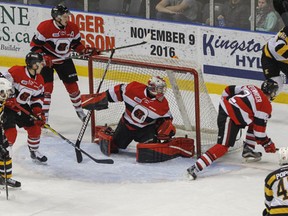 Kingston Frontenacs Jason Robertson tries to get the puck from behind the Ottawa 67's net, which was then blocked by Ottawa 67's goaltender Olivier Lafreniere during the first period of Ontario Hockey League action at the Rogers K-Rock Centre in Kingston, Ont. on Wednesday, November 30, 2016. (JULIA MCKAY/Whig-Standard/Postmedia Network)