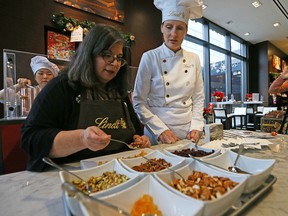 Rita DeMontis makes chocolate with Ann Czaja from Lindt on Tuesday November 29, 2016. Dave Abel/Postmedia Network