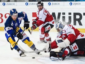 Davos' Gregory Sciaroni scores against Team Canada's Jeff Glass during a game at the 89th Spengler Cup hockey tournament in Davos, Switzerland on Dec. 30, 2015. (THE CANADIAN PRESS/AP-Gian Ehrenzeller/Keystone via AP)