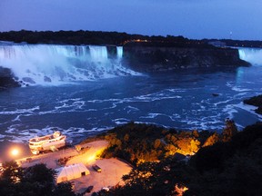 In this July 22, 2013, file photo, the Canadian side of the American Falls and Horseshoe Falls are illuminated in blue to celebrate the birth of the Duke and Duchess of Cambridge's son in Niagara Falls, Ontario. Officials say new energy-efficient LED lighting being unveiled Thursday, Dec. 1, 2016, will provide brighter and more robust color than the halogen technology that’s been used to cast the Falls in rainbow hues for the past 20 years. (AP Photo/Gary Wiepert, File)