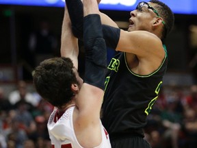 In this March 27, 2014, file photo, Wisconsin forward Frank Kaminsky, left, defends as Baylor center Isaiah Austin shoots during the second half of an NCAA men's college basketball tournament regional semifinal, in Anaheim, Calif. (AP Photo/Jae C. Hong, File)
