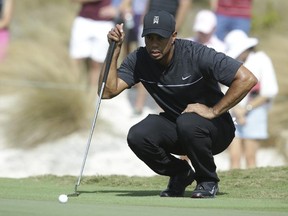 Tiger Woods lines up a putt on the first hole during the first round at the Hero World Challenge golf tournament in Nassau, Bahamas, on Thursday, Dec. 1, 2016. (Lynne Sladky/AP Photo)