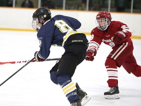Matthew Belanger of the St. Charles Cardinals chases down Joel Grandbois of College Notre Dame during boys high school hockey action in Sudbury, Ont. on Tuesday November 29, 2016. The two teams are expected to battle it out for top spot this season. Gino Donato/Sudbury Star/Postmedia Network