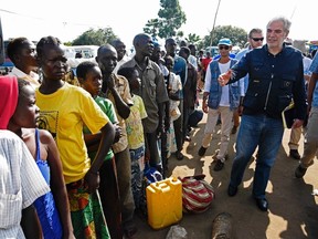 EU Commissioner for Humanitarian and Crisis Management, Christos Stylianides speaks with newly arrived refugees from South Sudan as they queue in line waiting to be registered on November 11, 2016 at Kuluba Reception Centre in Koboko District, North of the capital Kampala. Uganda, one of the world's poorest countries, currently hosts 530,000 South Sudanese refugees, 330,000 of whom fled fighting in the world's newest country this year alone. ISAAC KASAMANIISAAC KASAMANI/AFP/Getty Images