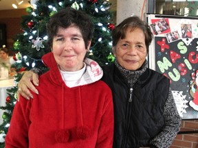 Mary Allen Aylesworth, left, and Trini Colley attend a Christmas dinner hosted by Ongwanada on Thursday. Colley and her husband, now deceased, decided to serve as a host family for Aylesworth, who has a developmental disability, almost 40 years ago. (Michael Lea/The Whig-Standard)