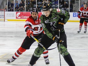 Kingston Frontenacs defenceman Eemeli Rasanen battles for the puck with Ottawa 67's Patrick White during Ontario Hockey League action at the Rogers K-Rock Centre on Nov. 4. (Julia McKay/Whig-Standard file photo)