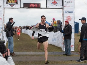 Lively's Ross Proudfoot holds up two fingers as he crossed the finish line at the Canadian cross-country running championships on Sunday, where he claimed his second straight national title. Supplied photo