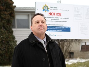 Chip Sawchuk, manager of the Alberta Sheriffs northern Alberta Safer Communities and Neighbourhoods unit, stands outside a property at 9103 137 Ave. in Edmonton on Thursday, Dec. 1, 2016, that was shuttered for 90 days after complaints of suspected drug activity and prostitution out of the home. CLAIRE THEOBALD/Postmedia