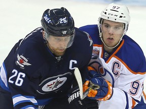 Connor McDavid and Jets Blake Wheeler tangle during Thursday's game in Winnipeg. (Brian Donogh)