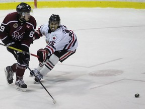 Blair Derynck of the Chatham Maroons chips the puck past Sarnia Legionnaires forechecker Yianni Skropolis during the Greater Ontario Junior Hockey League game at Sarnia Arena on Thursday, Dec. 1, 2016 in Sarnia, Ont. Skropolis scored twice but the Maroons won 5-2. (Terry Bridge/Sarnia Observer)