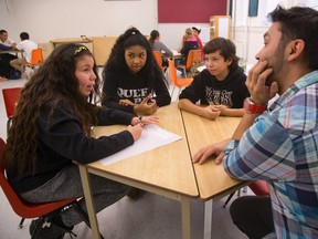 Mike Cywink an Indiginous adult mentor from Western University talks with Kaya Riley, 12, Naomi George, 13 and Braeden Bressette, 12 of Aberdeen Public School in London, Ont. Cywink, as part of a study by Western's Claire Crooks, had led a program meeting once a week with Indigenous students at the school to teach skills such as stress management and combined the skills with the spiritual, physical, mental and emotional teachings of the First Nations medicine wheel. (MIKE HENSEN, The London Free Press)