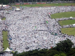 Indonesian Muslims gather during a rally against Jakarta's minority Christian Governor Basuki "Ahok" Tjahaja Purnama who is being prosecuted for blasphemy, at the National Monument in Jakarta, Indonesia, Friday, Dec. 2, 2016. Tens of thousands of conservative Muslims rallied in the Indonesian capital on Friday in the second major protest in a month against its minority Christian governor. (AP Photo/Tatan Syuflana)