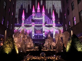 Christmas angels frame the side of the Saks Fifth Avenue store which was aglow with lights across from Rockefeller Center during the 84th annual Rockefeller Center Christmas tree lighting ceremony, Wednesday, Nov. 30, 2016, in New York. The 94-foot tall Norway spruce is covered with 50,000 multicolored LED lights. (AP Photo/Julie Jacobson)