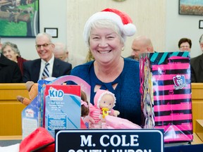 South Huron mayor Maureen Cole shows off the doll she got during the mock gift exchanged. (Darryl Coote/The Goderich Signal Star)