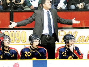 Queen's Gaels men's hockey head coach Brett Gibson behind the Gaels bench during action in North Bay. (Postmedia Network file photo)