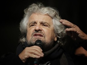 The leader of the Five Star Movement, Beppe Grillo, delivers a speech during a campaign meeting upon a referendum on constitutional reforms, on December 2, 2016 in Piazza San Carlo in Turin. (AFP PHOTO / MARCO BERTORELLO)