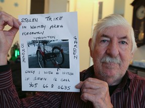 Ian Richards of Whitby holds a picture of his stolen trike on Dec. 2, 2016. (Veronica Henri/Toronto Sun)