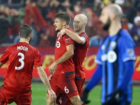 Toronto FC celebrate Nick Hagglund’s (centre) series-tying goal against the Montreal Impact during the Eastern Conference final on Wednesday night. (DAVE ABEL/Toronto Sun)