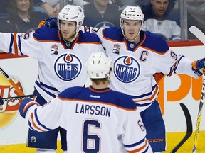 Edmonton Oilers Leon Draisaitl (29), Adam Larsson (6) and Connor McDavid (97) celebrate Draisaitl's goal against the Winnipeg Jets during third period NHL action in Winnipeg on Thursday, December 1, 2016.