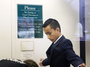 In this April 2, 2014 file photo, Justin Casquejo passes through security at a courthouse in New York. (AP Photo/Seth Wenig, File)