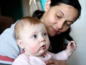Jennifer Colbeck cuddles six-month-old Avaline in one of the child care rooms offered through the Terra Centre for Teen Parents at Braemar School at 9359 67A Street in Edmonton on Dec. 2, 2016. Despite opening ten new spaces in their child care facilities, even parents who apply long before their baby is born aren't guaranteed a spot. CLAIRE THEOBALD