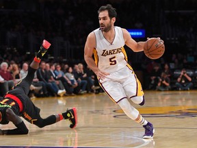 Former Raptors guard Jose Calderon (right) returned to Toronto with the Lakers on Friday night. (Mark J. Terrill/AP Photo)