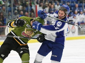 Darian Pilon, right, of the Sudbury Wolves, and Riley Bruce, of the North Bay Battalion, scuffle during OHL action at the Sudbury Community Arena in Sudbury, Ont. on Friday December 2, 2016. John Lappa/Sudbury Star/Postmedia Network