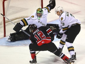 Nick Pryce of the Owen Sound Attack tries to pass across the crease rather than shoot on Knights goaltender Tyler Parsons while being checked by Nicolas Mattinen during the first period of their game at Budweiser Gardens in London, Ont. on Friday December 2, 2016. (MIKE HENSEN, The London Free Press)
