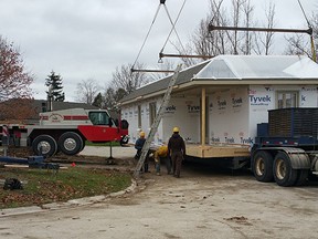 The show house about to be placed on the foundation December 2. (Shaun Gregory/Huron Expositor)