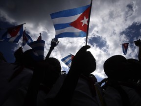 People wave as the ashes of late Cuban leader Fidel Castro arrive at Parque Cespedes in Santiago de Cuba, on December 3, 2016.
The convoy carrying the ashes of Cuba's late communist leader Fidel Castro ends an island-wide journey on Saturday in the cradle of his revolution for a big ceremony before his burial. / AFP PHOTO / RODRIGO ARANGUARODRIGO ARANGUA/AFP/Getty Images