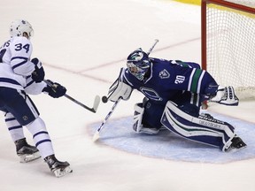 Maple Leafs' Auston Matthews (left) is stopped by Canucks goaltender Ryan Miller in the shootout during NHL action in Vancouver on Saturday, Dec. 3, 2016. (Ben Nelms/The Canadian Press)