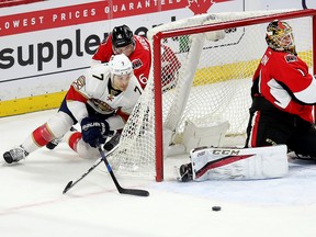 Senators’ Chris Wideman tries to trac k down Panthers’ Colton Sceviour as his wrap-around attempt is thwarted by Sens goalie Mike Condon during the second period on Saturday night in Ottawa. (WAYNE CUDDINGTON/POSTMEDIA NETWORK)