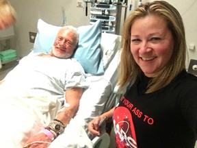 In this Friday, Dec. 2, 2016, photo provided by Christina Korp, right, Buzz Aldrin lies in a hospital bed in Christchurch, New Zealand. Aldrin, the second man to walk on the moon, was evacuated from the South Pole to New Zealand where he was hospitalized in stable condition. (Christina Korp via AP)