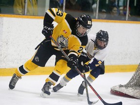 Nickel City Bruins Cole Recollet and Huntsville Otters Rylan Holman battle for the puck during Sudbury Silver Stick pee wee A championship game action in Sudbury, Ont. on Sunday December 4, 2016. Gino Donato/Sudbury Star/Postmedia Network