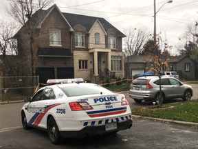 Police are pictured last week at a house where accused murderer Dr. Mohammed Shamji lived. (JOE WARMINGTON, Toronto Sun)