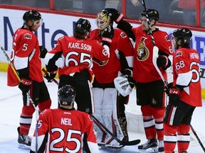 Senators' Erik Karlsson and fellow teammates congratulate goaltender Mike Condon on his 2-0 shutout win against the Florida Panthers on Saturday in Ottawa. The Sens hit are in Pittsburgh on Monday. (THE CANADIAN PRESS/PHOTO)