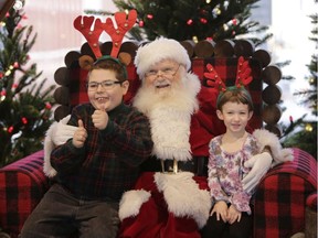 Alexander Sinclair, who is autistic, sits with his sister Ruby on Santa's chair as part of the Sensory Santa program, at the Rideau Centre in Ottawa on Dec. 4, 2016. This is the third year of the program organized by QuickStart which allows families to bring their autistic children to visit Santa for a photo during designated hours when the crowds and noise are at a minimum. (David Kawai)